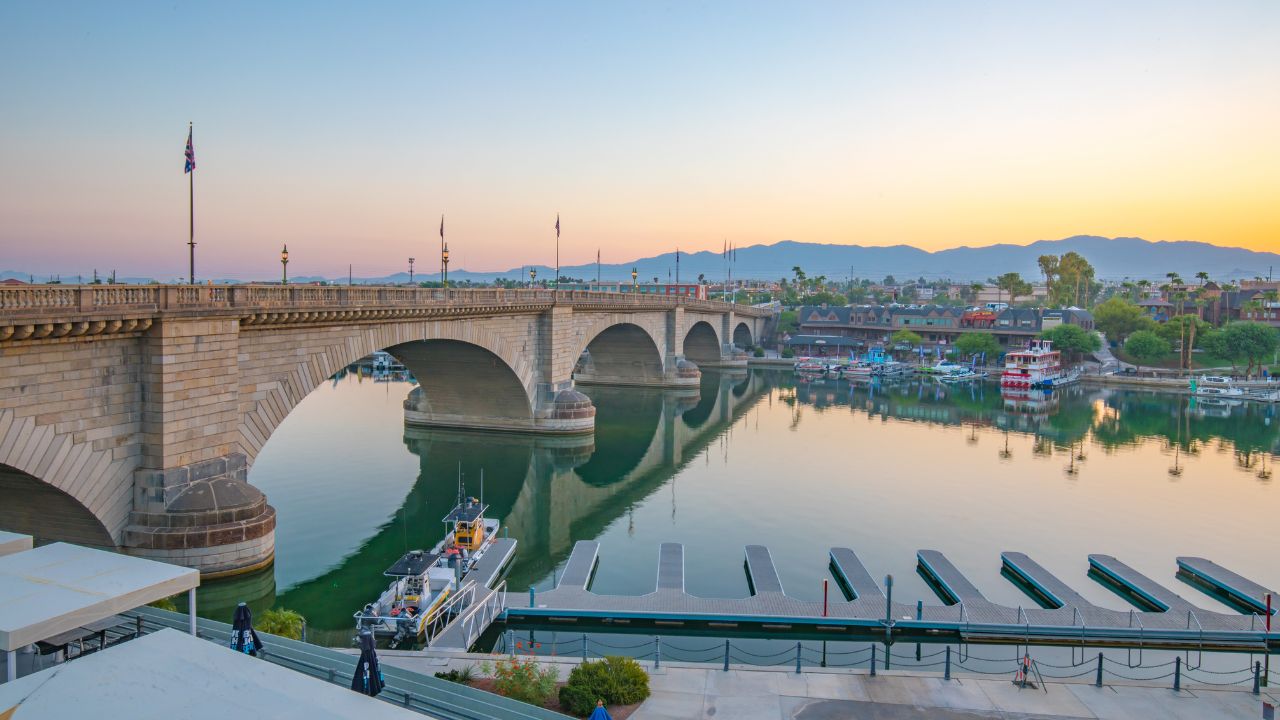 Lake Havasu City, AZ 8-30-21: London Bridge at sunrise. Formerly spanning the River Thames in England, this historic bridge was purchased and shipped to Arizona in 1971. View from Heat Hotel balcony.
