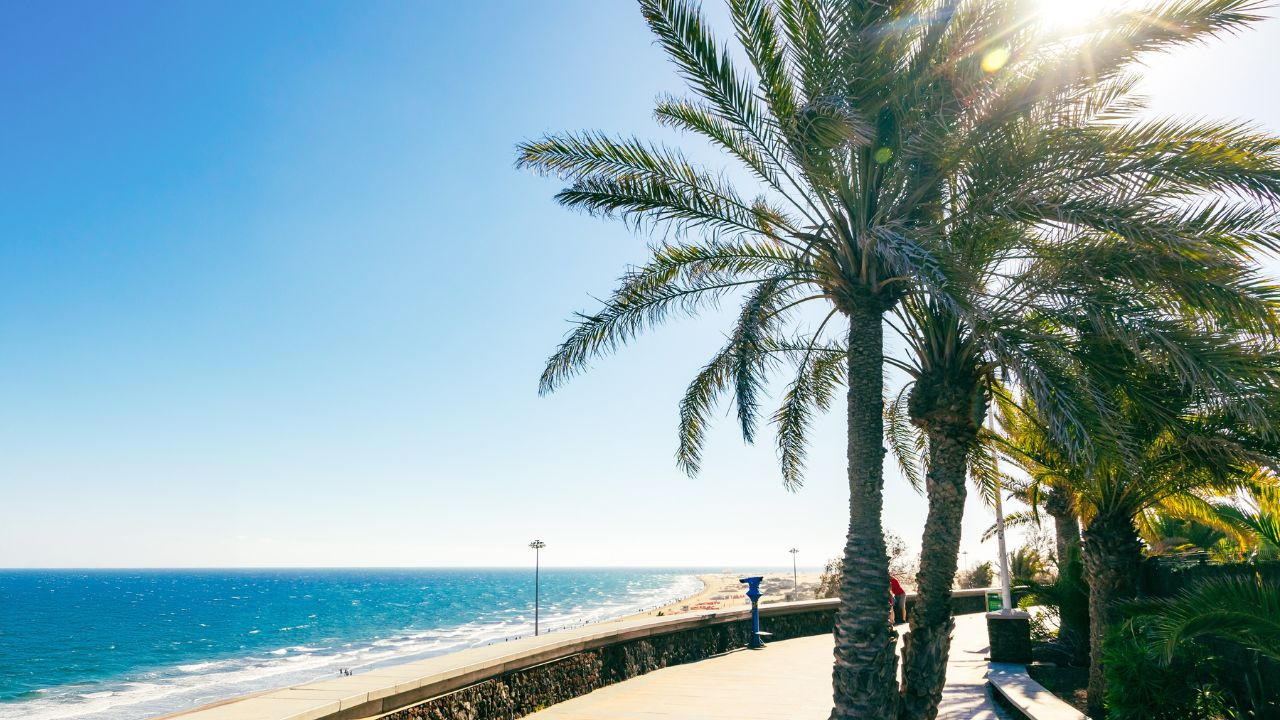 One of the best beach in the Canaries - Maspalomas Beach (Playa de Maspalomas). Sunny view of Maspalomas promenade, Gran Canaria island, Canary Islands, Spain