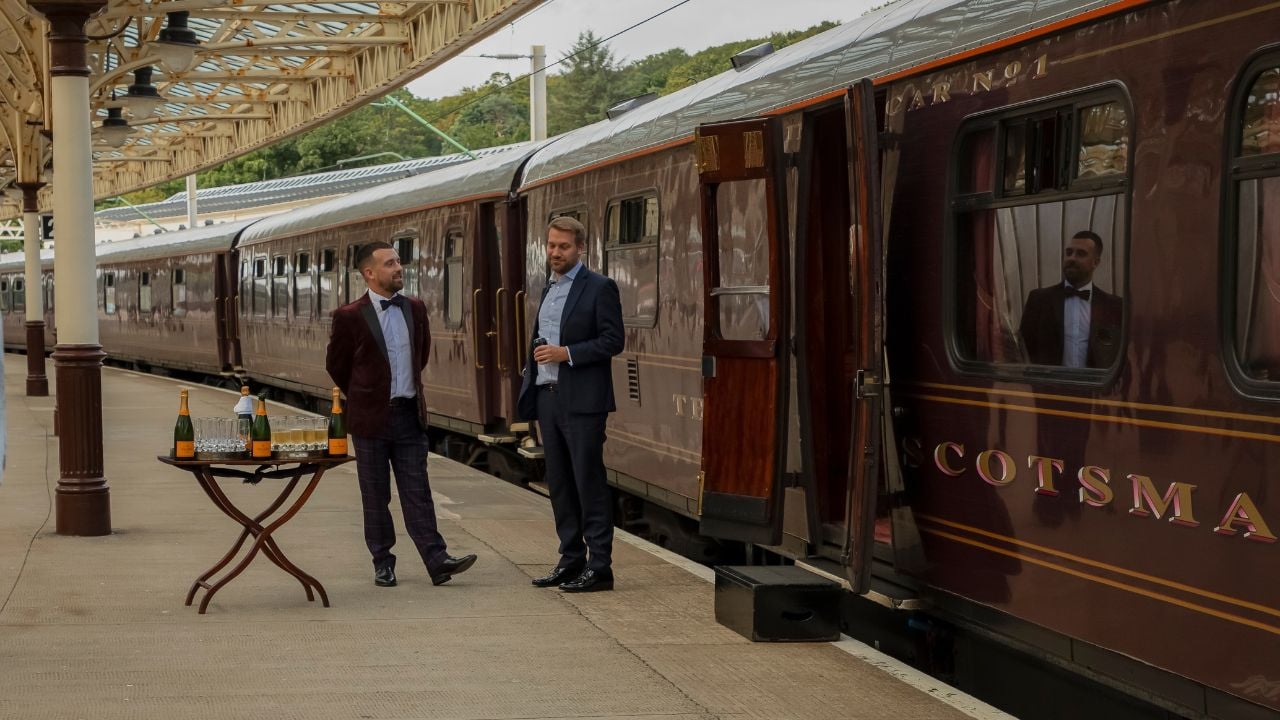 Wymess Bay, Scotland, United Kingdom - July 30th 2023 - Two waiters waiting for the passengers to arrive and to board the Royal Scotsman luxury train