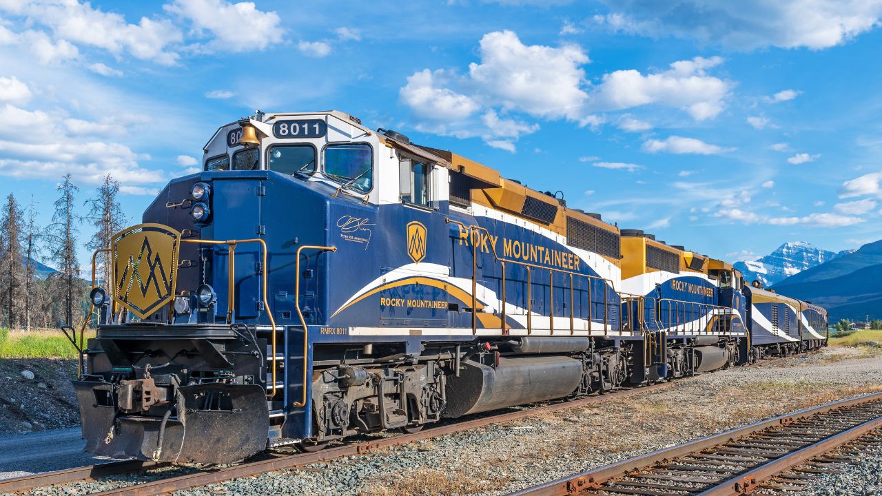 JASPER, CANADA - JULY 23, 2022: Rocky Mountaineer train locomotive in Jasper national park with Edith Cavell mountain.