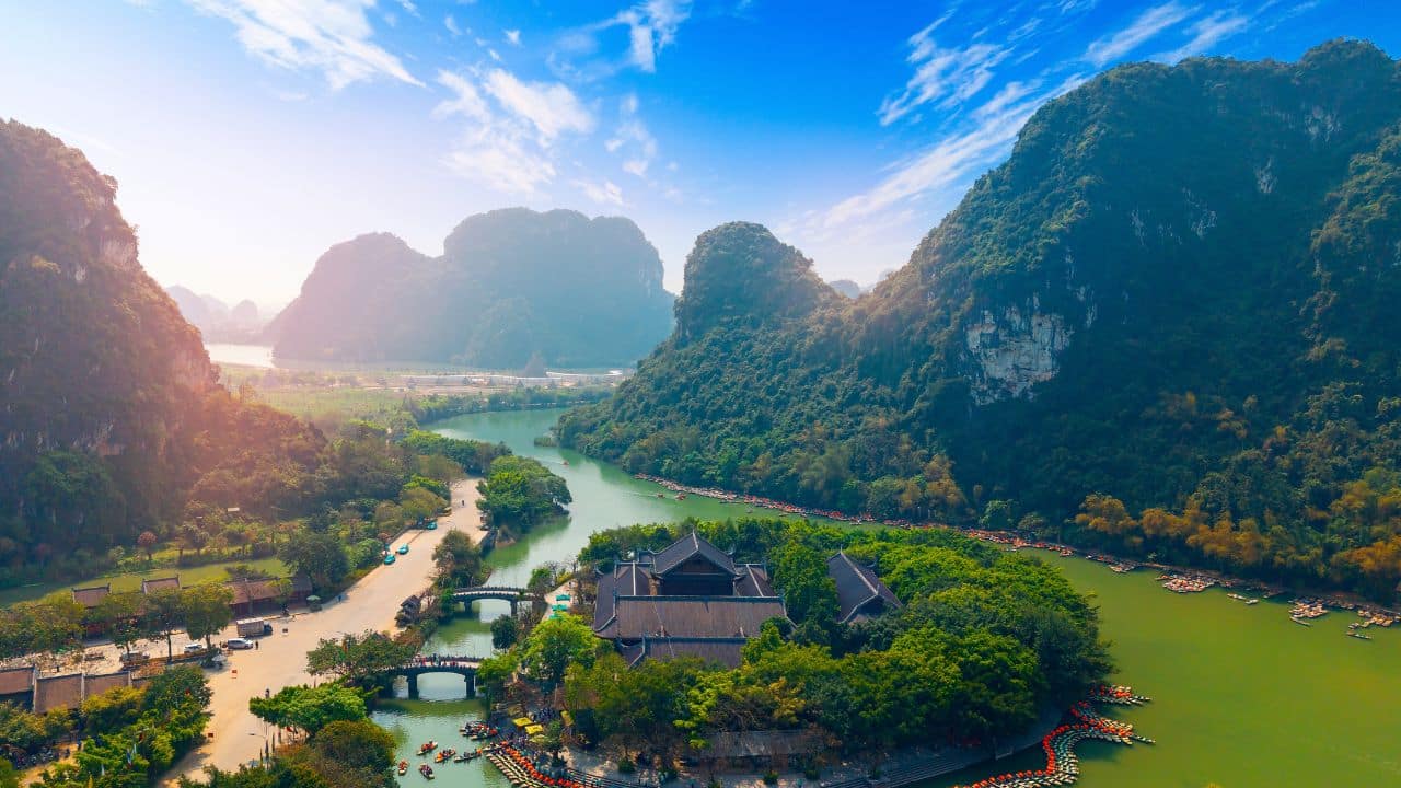 Scenic landscape of Ninh Binh Vietnam with lush mountains and river, travel landmark of Viet.
