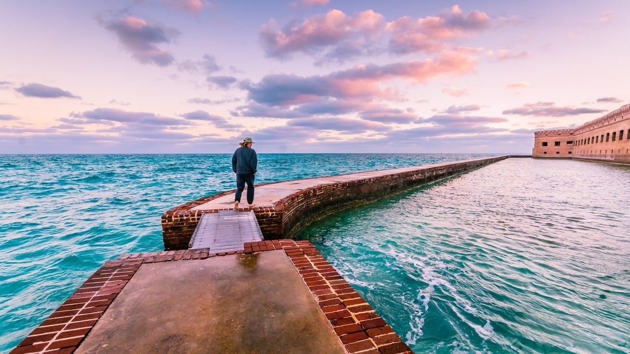 Man takes a morning walk on the moat around Port Jefferson at Dry Tortugas National Park in the Florida Keys.