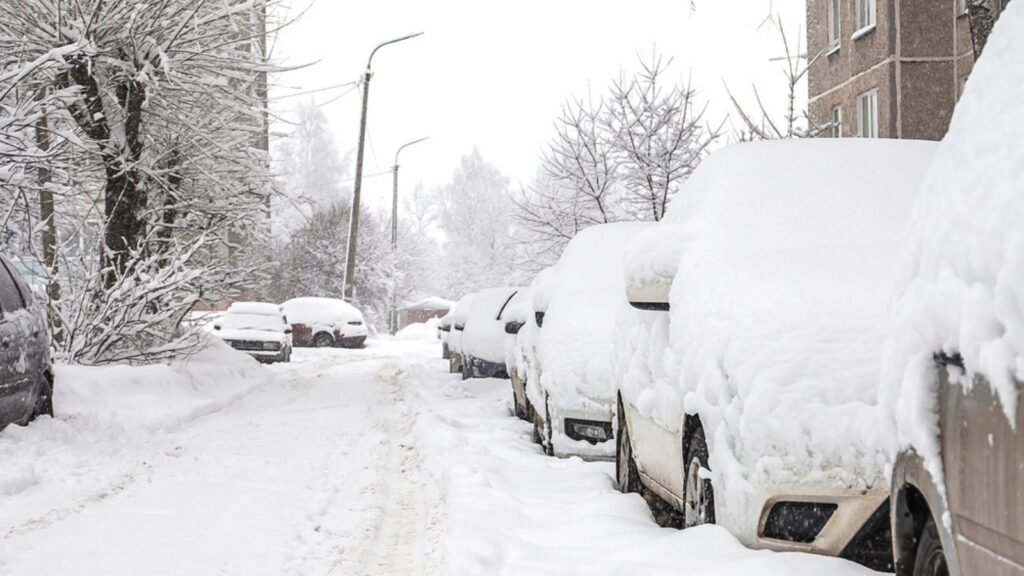Machines covered with snow, winter snowstorm. Vehicles are covered with snow, bad weather.