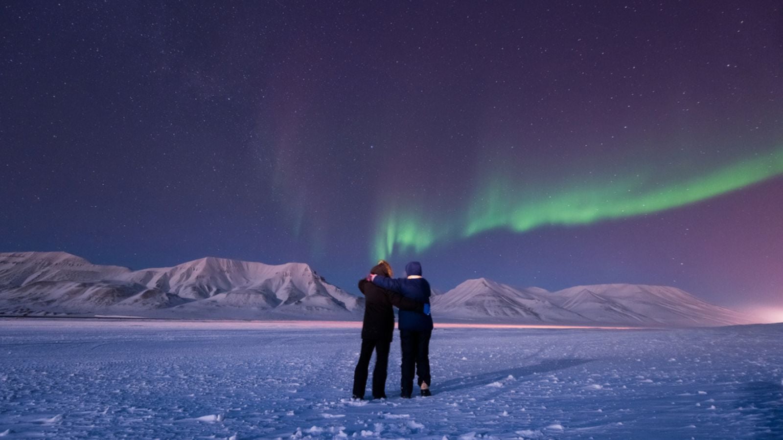 The polar arctic Northern lights aurora borealis sky star in Norway Svalbard in Longyearbyen city man people mountains