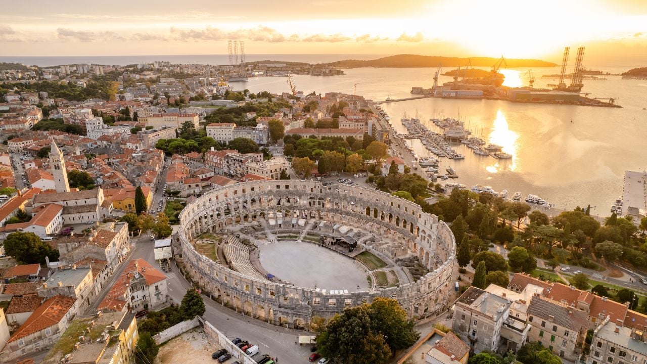 Aerial view of the historic Roman Amphitheatre of Pula at sunset, Istria Peninsula, Croatia. Ruins of the Roman Colosseum Arena in Pula, Croatia. UNESCO World Heritage site