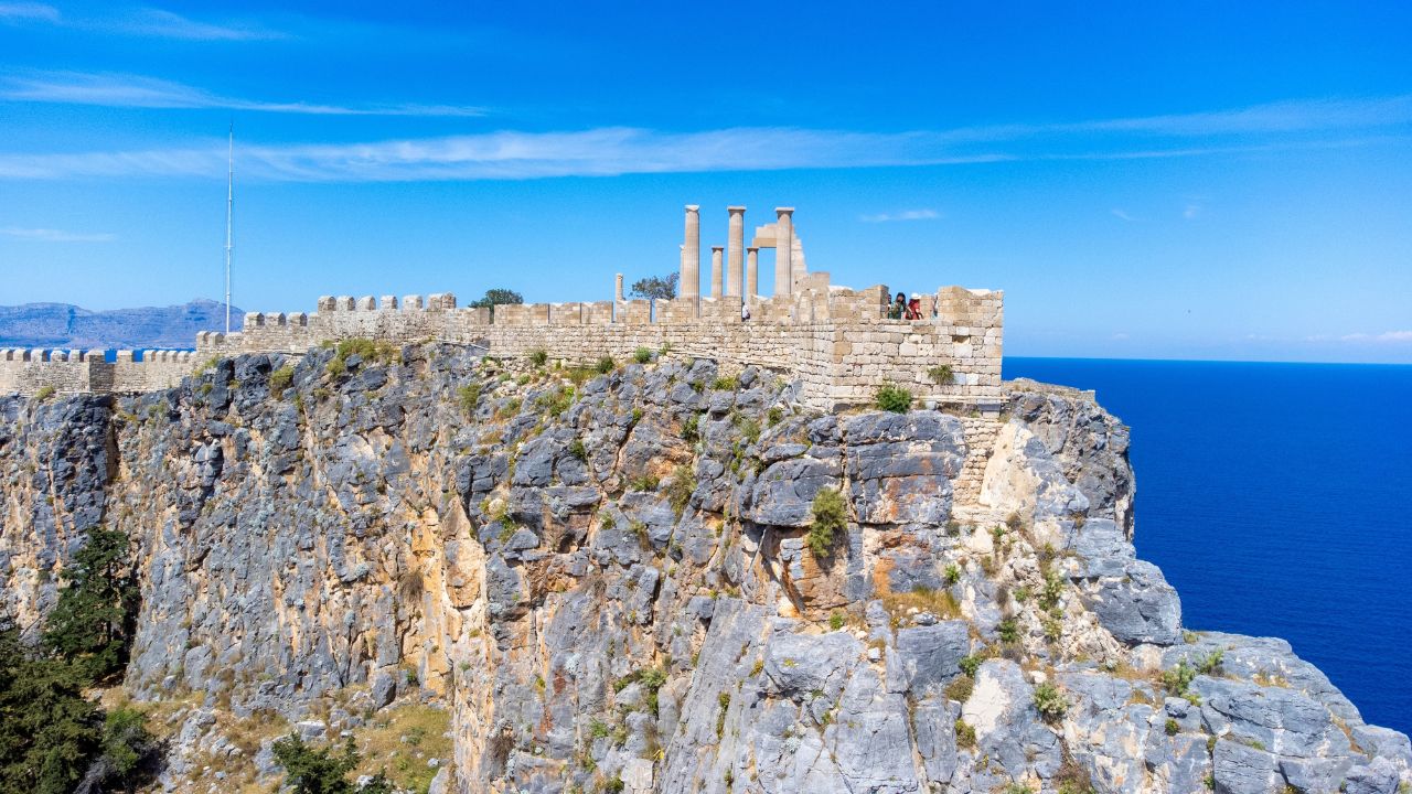 The Acropolis of Lindos in Rhodes island Greece. Saint Paul's Beach and Lindos Acropolis aerial panoramic view.