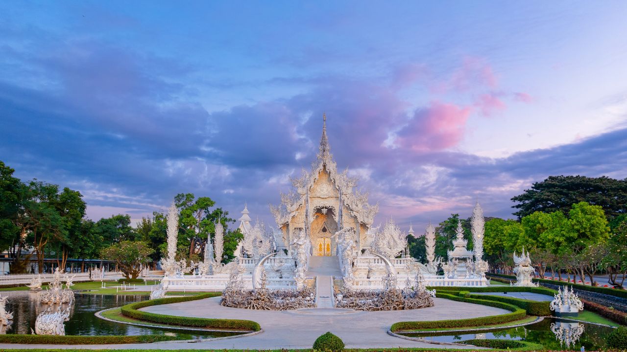White temple wat rong khun in Chiang Rai, Thailand, architectural Buddhism at sunset.