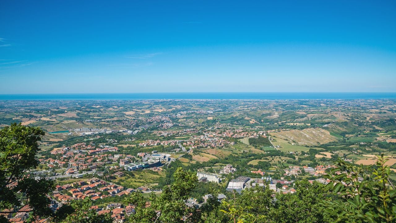 Panorama of Republic of San Marino and Italy from Monte Titano, City of San Marino. City of San Marino is capital city of Republic of San Marino located on Italian peninsula, near Adriatic Sea.