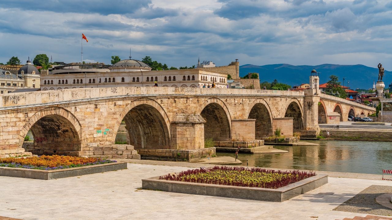 Skopje, North Macedonia - August 10 2023: Stone Bridge across the Vardar River in Skopje, North Macedonia