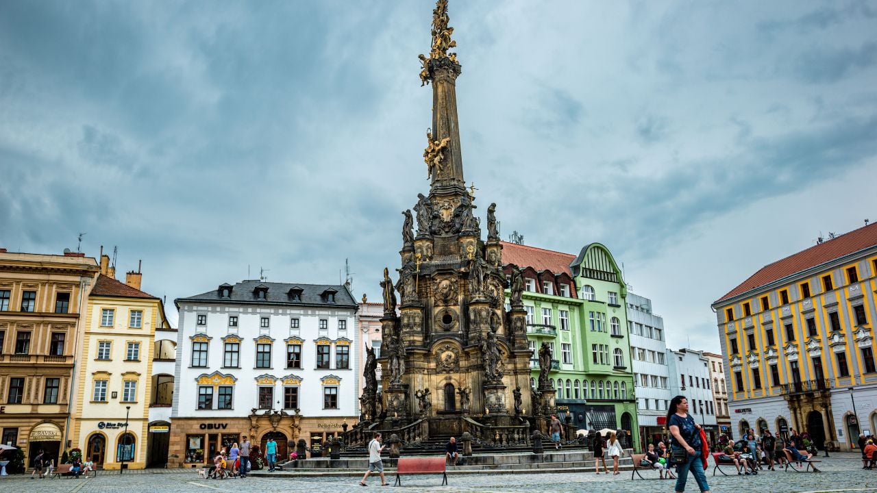 OLOMOUC, CZ - Jul 27, 2023: The Holy Trinity Column in Olomouc city with people walking around, and buildings in the background