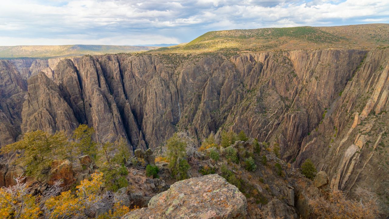 Scenic view of Black Canyon of the Gunnison National Park with rugged cliffs and clear sky in Colorado.