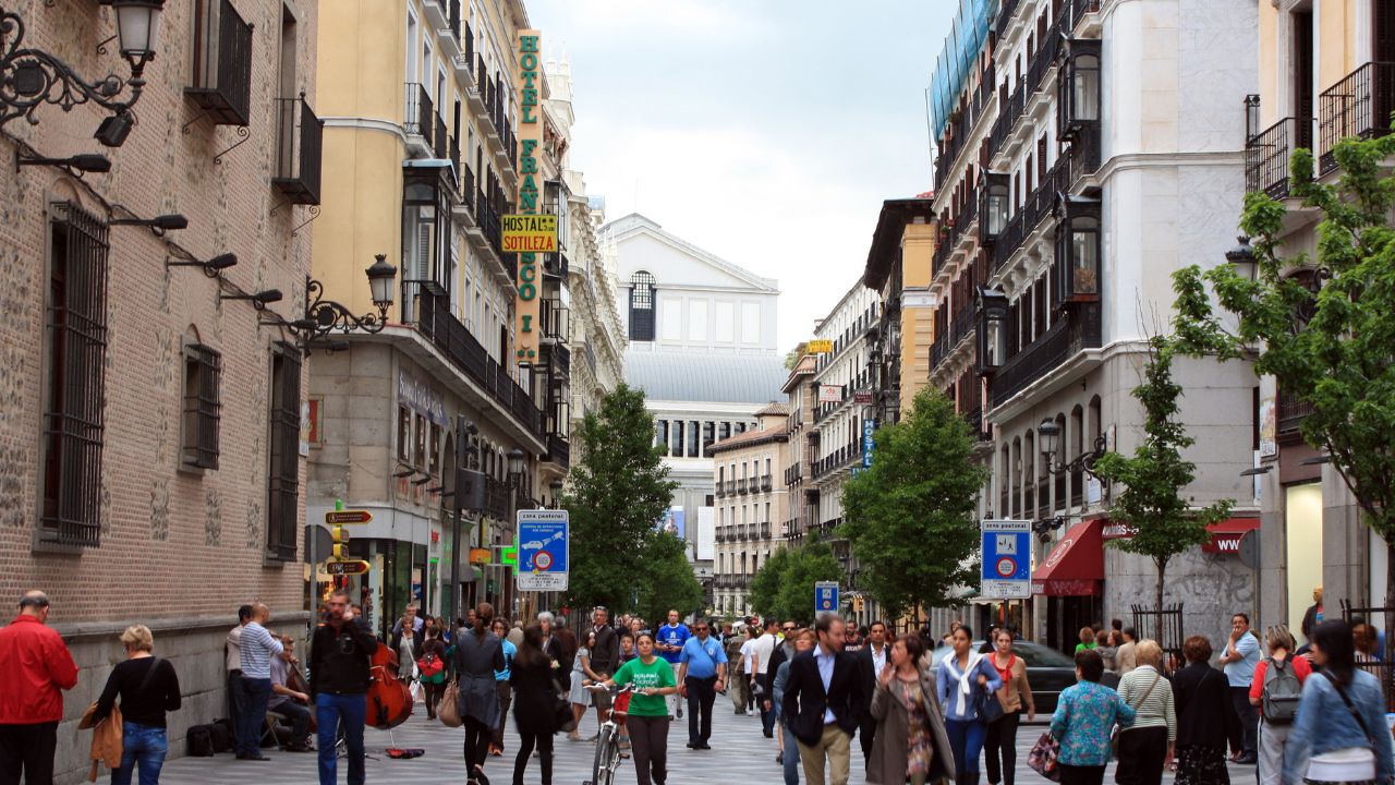 MADRID, SPAIN - APRIL 9: People walking on the street Arenal background Royal Opera House, May 9, 2013 in Madrid, Spain.