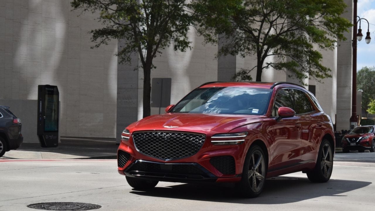 Houston, TX USA 9-21-2024 - A portrait of a red Genesis GV70 luxury SUV in the downtown metropolis of Houston.