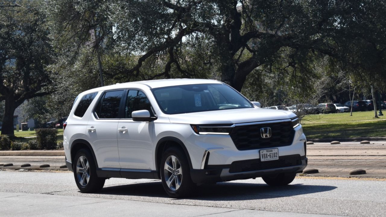 Houston, TX USA- A Honda Pilot SUV cruising near train tracks with a beautiful background.