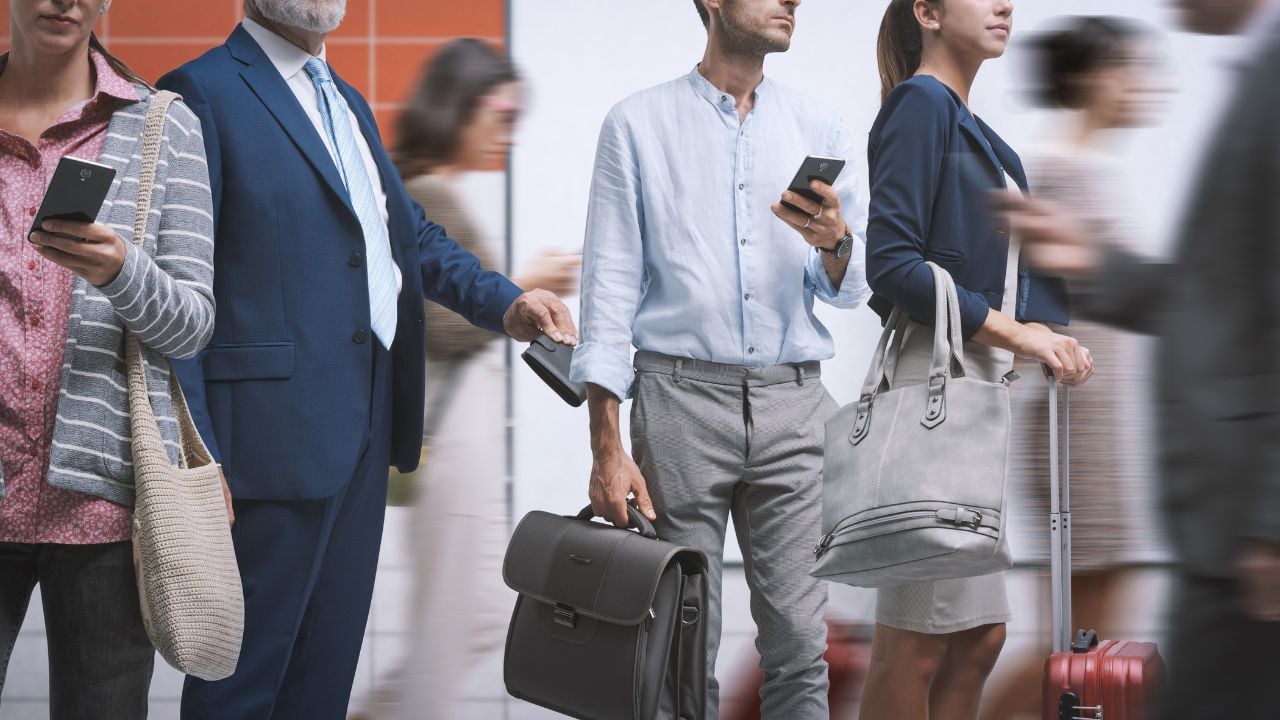 Quick thief pickpocketing in the crowded city street, he is stealing a wallet from a man's pocket