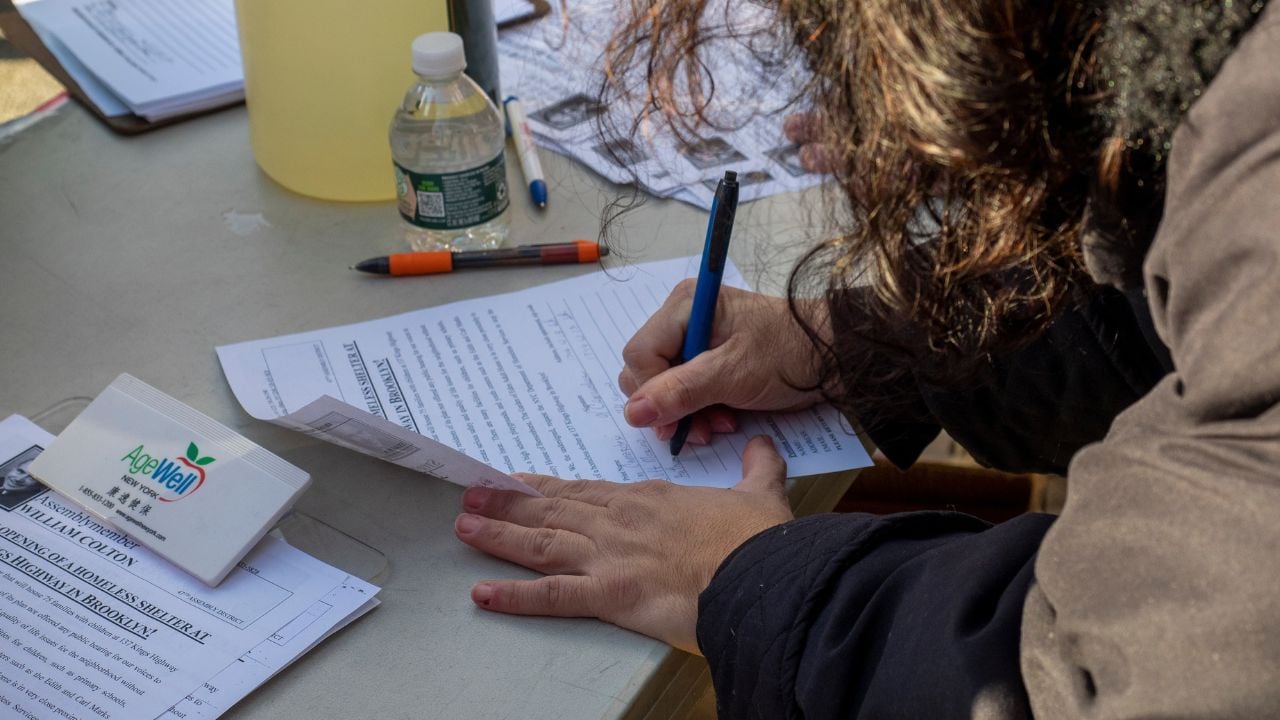 Brooklyn NY, USA - January 23, 2022: People signing petitions during the RALLY TO STOP THE PROPOSED BUILDING OF HOMELESS SHELTERS at 137 KINGS HIGHWAY