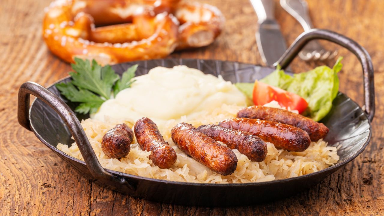 Nuremberg sausages with sauerkraut on wood