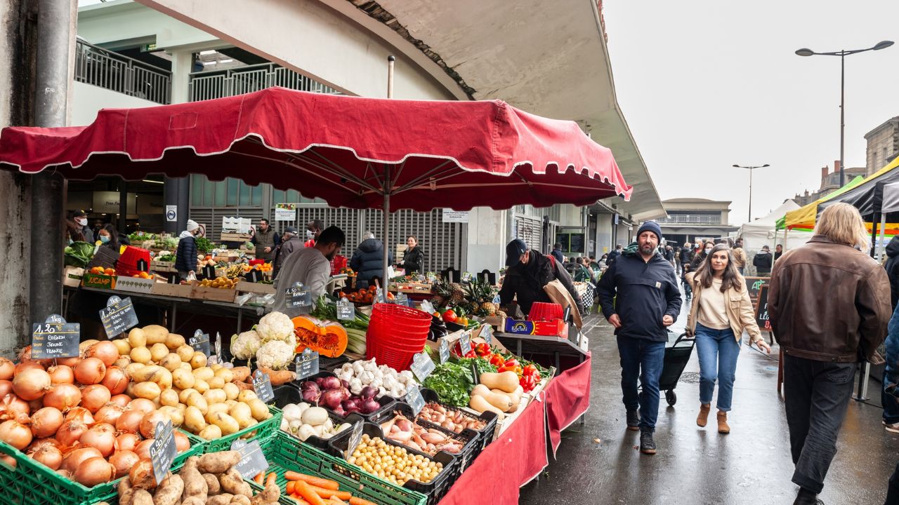 BORDEAUX, FRANCE - FEBRUARY 20, 2022: Selective blur on people, clients, buying groceries in crowd in Bordeaux, in Marche des Capucins, one of the main green farmers market of Aquitaine.BORDEAUX, FRANCE - FEBRUARY 20, 2022: Selective blur on people, clients, buying groceries in crowd in Bordeaux, in Marche des Capucins, one of the main green farmers market of Aquitaine. BORDEAUX, FRANCE - FEBRUARY 20, 2022: Selective blur on people, clients, buying groceries in crowd in Bordeaux, in Marche des Capucins, one of the main green farmers market of Aquitaine. BORDEAUX, FRANCE - FEBRUARY 20, 2022: Selective blur on people, clients, buying groceries in crowd in Bordeaux, in Marche des Capucins, one of the main green farmers market of Aquitaine.