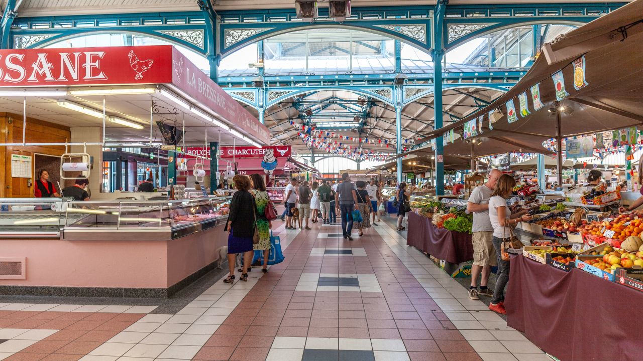 Dijon, France - September 3, 2016: people enjoy walking and shopping in the traditional market hall in the center of Dijon, Burgundy, France.