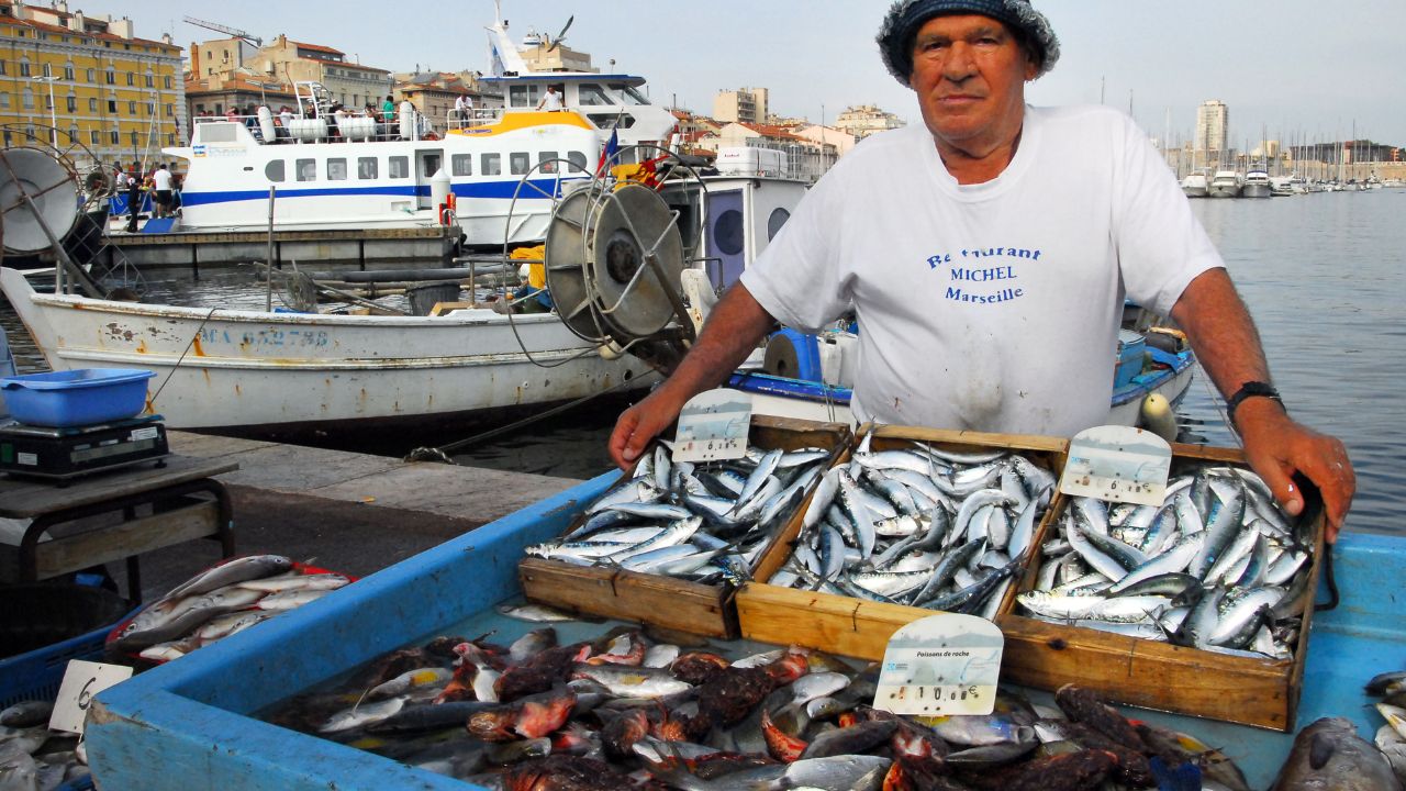 MARSEILLE - MAY 09 2008:French fisherman selling fresh fish at Vieux Port in Marseille, France. Marseille is France's largest city on the Mediterranean coast and the largest commercial port.