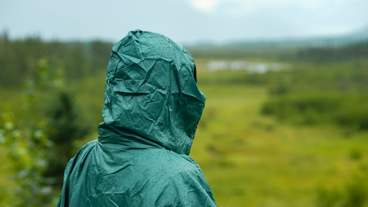 Hiking in the rain wearing rain poncho, Chugach State Park, Alaska