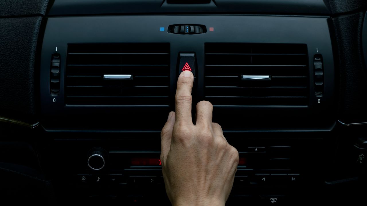 Close up hand press the emergency light in the car, Fingers press button.for open the contract emergency light in car. Emergency button press for open emergency light warning sign symbol out side carClose up hand press the emergency light in the car, Fingers press button.for open the contract emergency light in car. Emergency button press for open emergency light warning sign symbol out side car