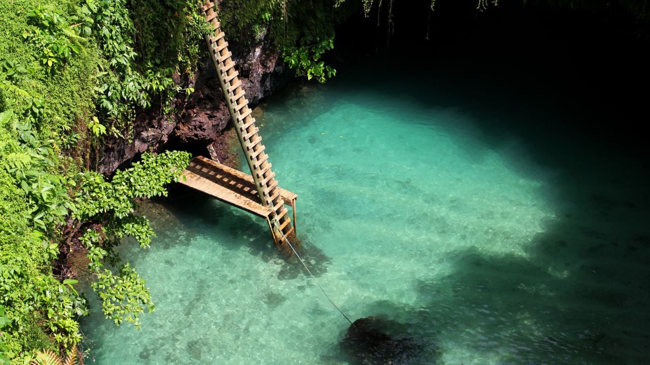 To-Sua Ocean Trench is located on the southeast coast of Upolu Island in Samoa. Its a massive swimming hole filled with blue water and surrounded by lush vegetation.