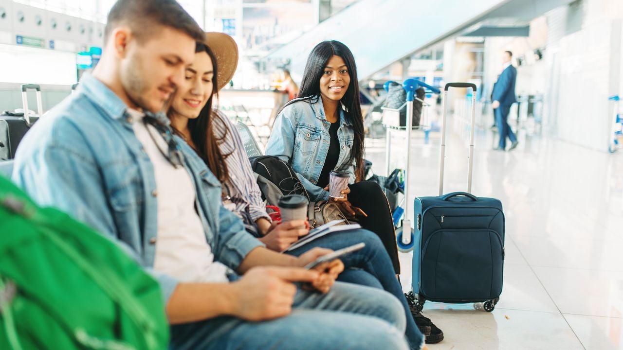 Couple with luggage waiting for departure, airport