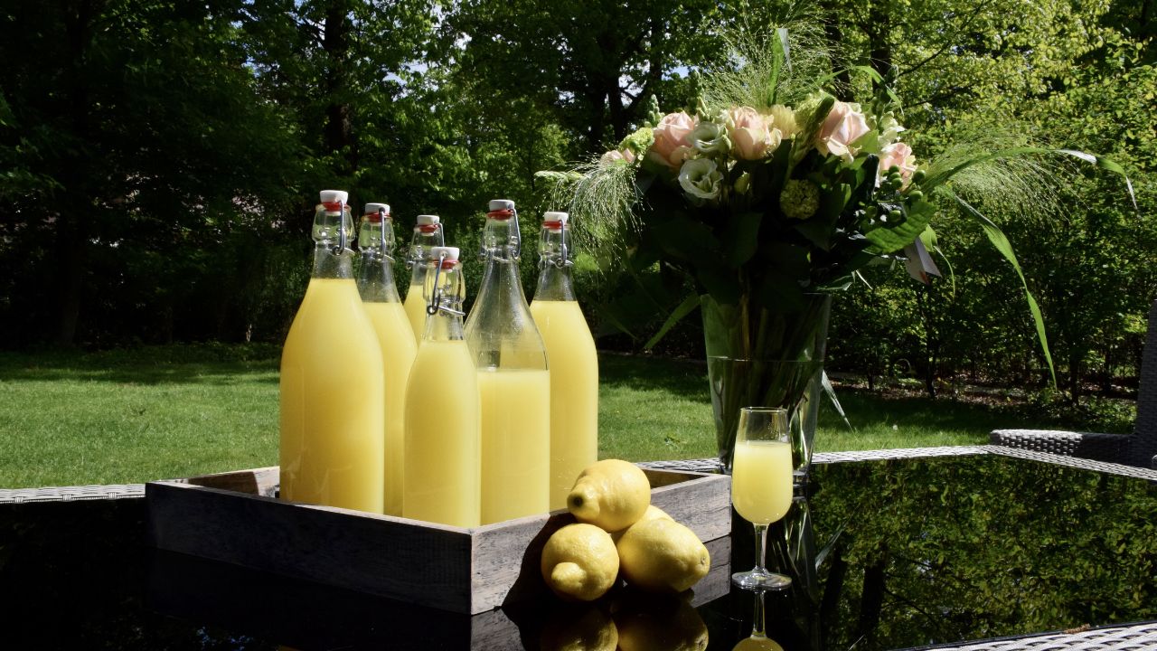 A selective of homemade limoncello in a garden