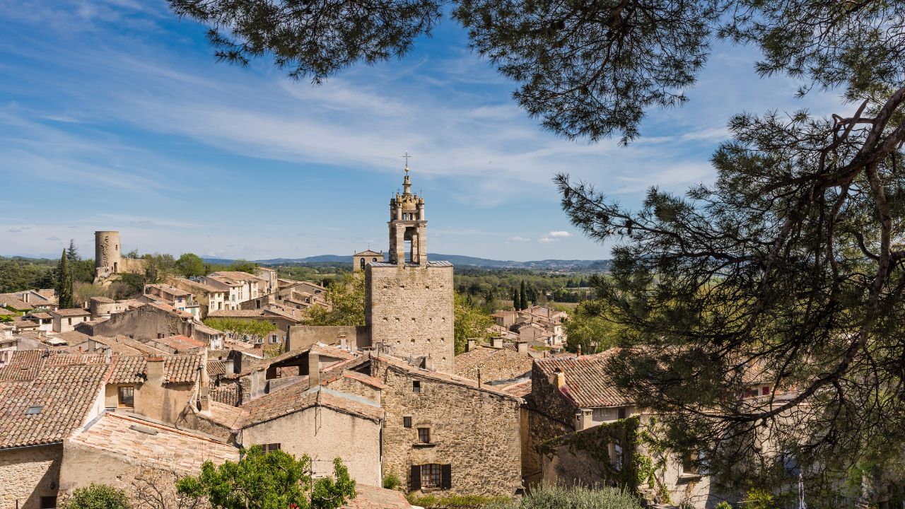 Cucuron, France - April 2022 : Clock tower of the village of Cucuron in the Luberon valley in Provence, France