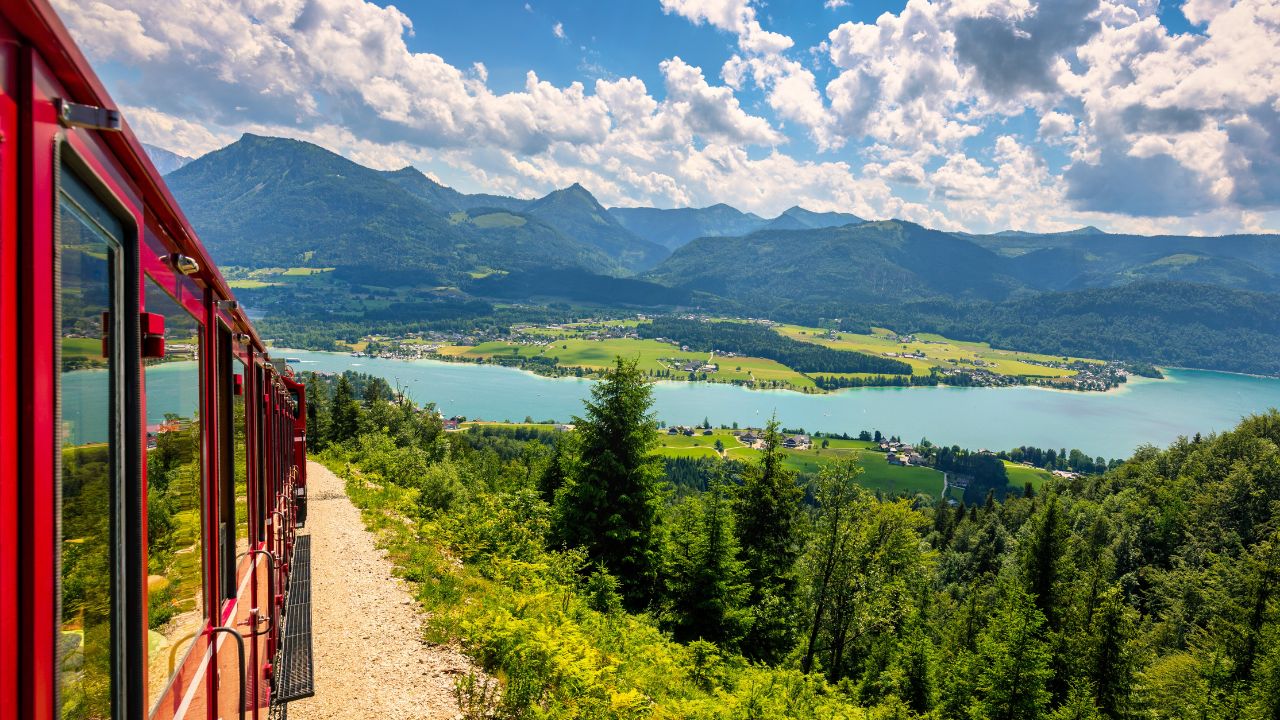 Schafbergbahn mountain train, Schafberg mountain, Salzkammergut region, Salzburg Land state, Austria. Journey to the top of Alps through lush fields and green forests.View of lake Wolfgangsee.