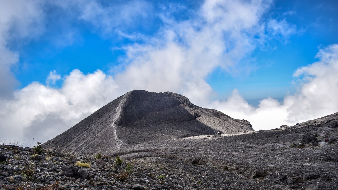 Beautiful peak with cloud of a mountain captured from Merapi, Indonesia on sunny day.