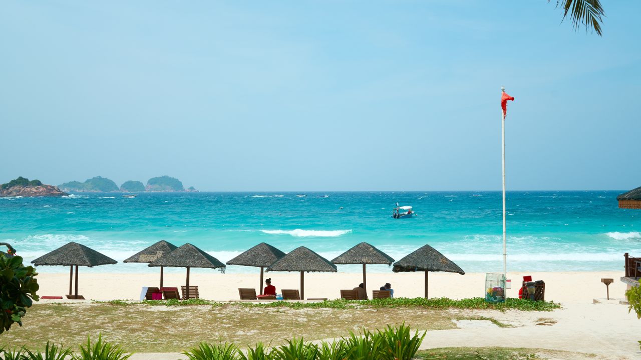 Tourists are enjoying a sunny day on a tropical beach in redang island, malaysia