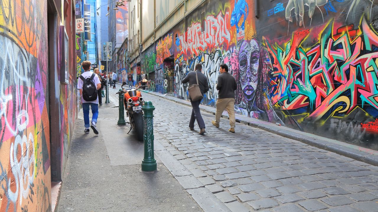 MELBOURNE AUSTRALIA - AUGUST 23, 2014: Unidentified people sightsee Hoiser lane - Melbourne's graffiti management plan recognises the importance of street art.