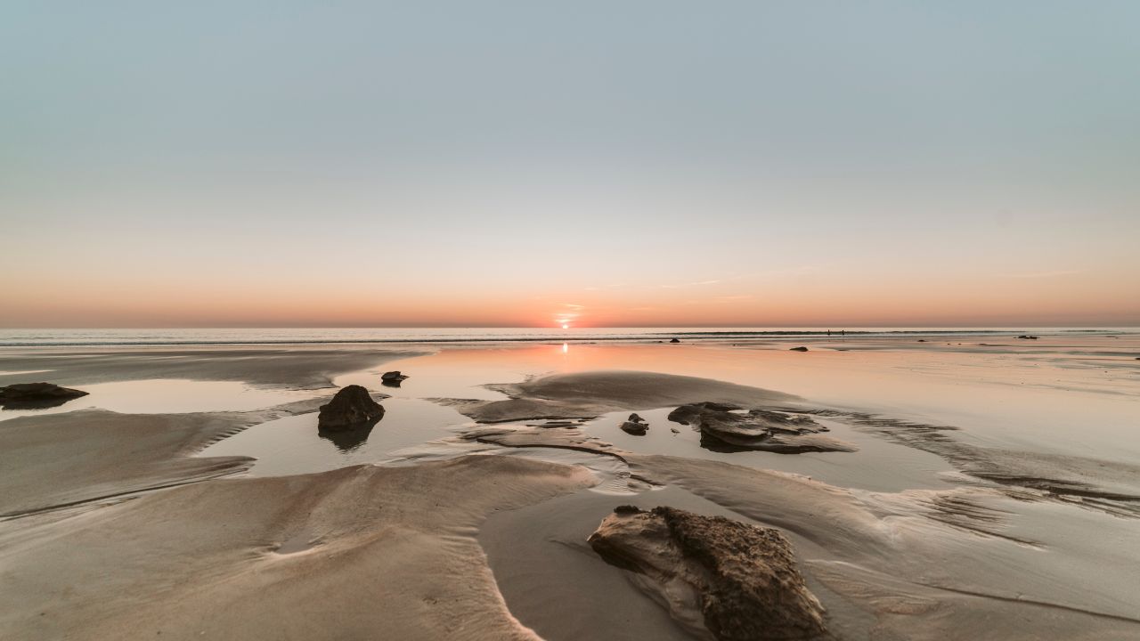 Amazing australian sunset during low tide on Cable Beach, Broome. This is one of the best beaches in Australia and perfect for backpackers and other travelers. Concept: travel Australia.