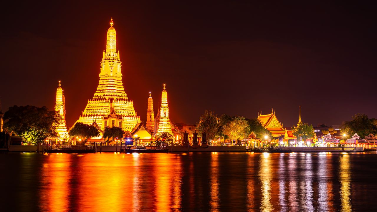 Wat Arun Ratchawararam Ratchawaramahawihan or Wat Arun, Buddhist temple along the Chao Phraya river at night sky in Bangkok, Thailand