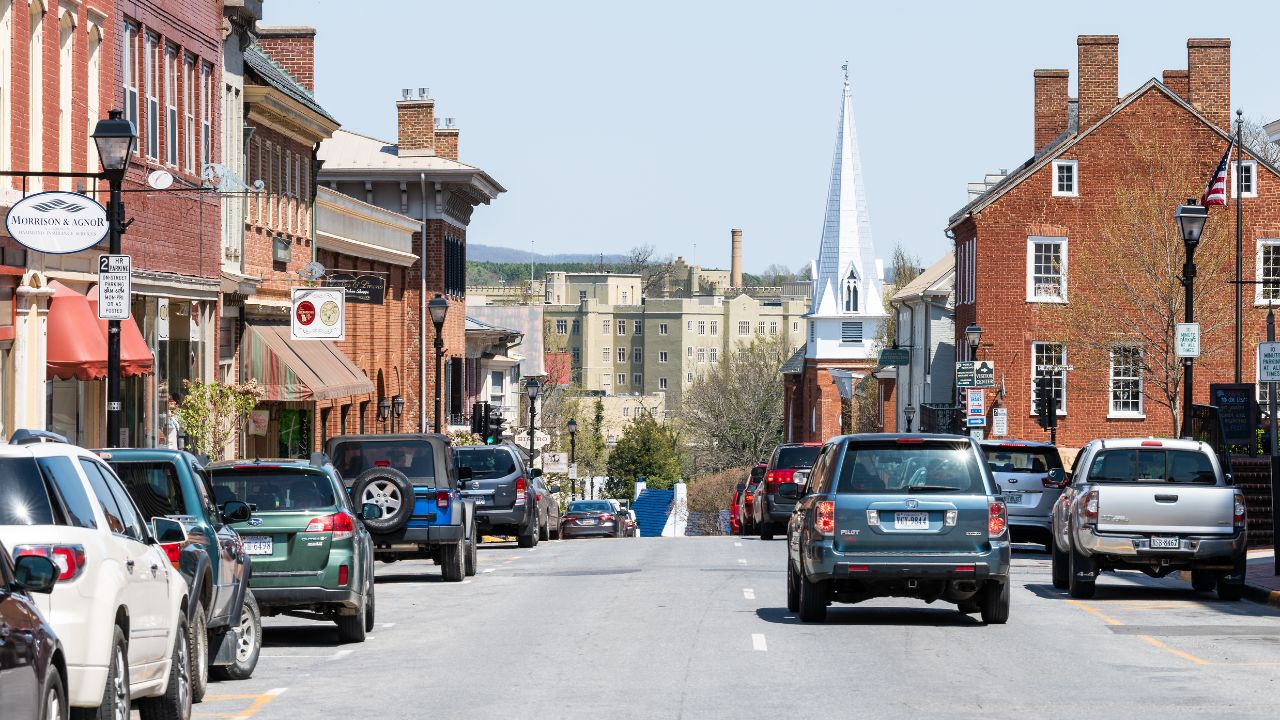Lexington, USA - April 18, 2018: Historic downtown town city in Virginia countryside Shenandoah mountain village, signs for shops and stores, First Baptist church on main street