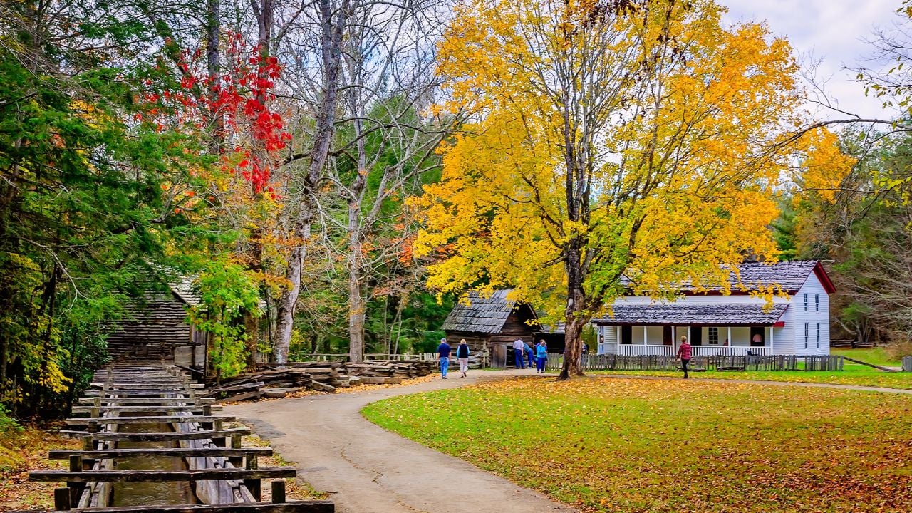Townsend, Tennessee, USA - Nov. 2, 2017: The Cable Grist Mill mill race is pictured with the smokehouse and Gregg-Cable House in Great Smoky Mountains National Park.