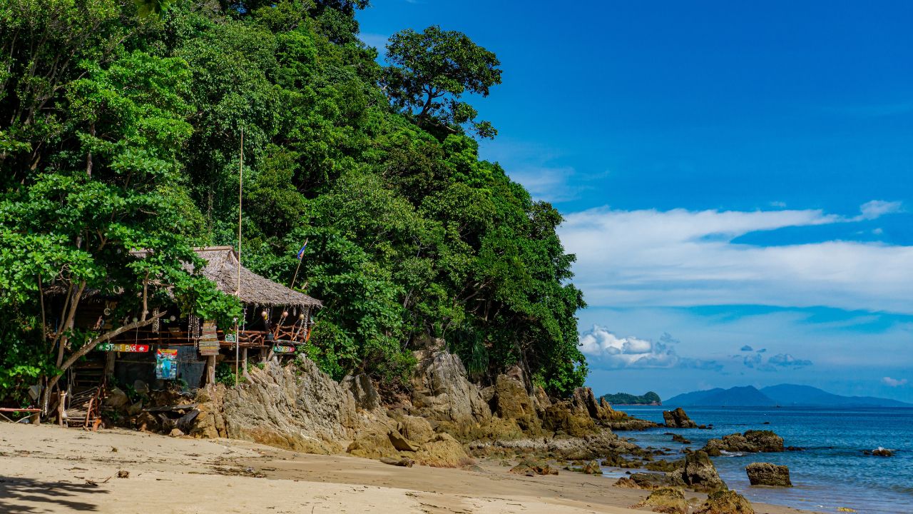 Koh Jum, Thailand-Jun 202: Beautiful sunny day at the beach with a perfect view over the open sea. Enjoying the tropical summer environment of the world.