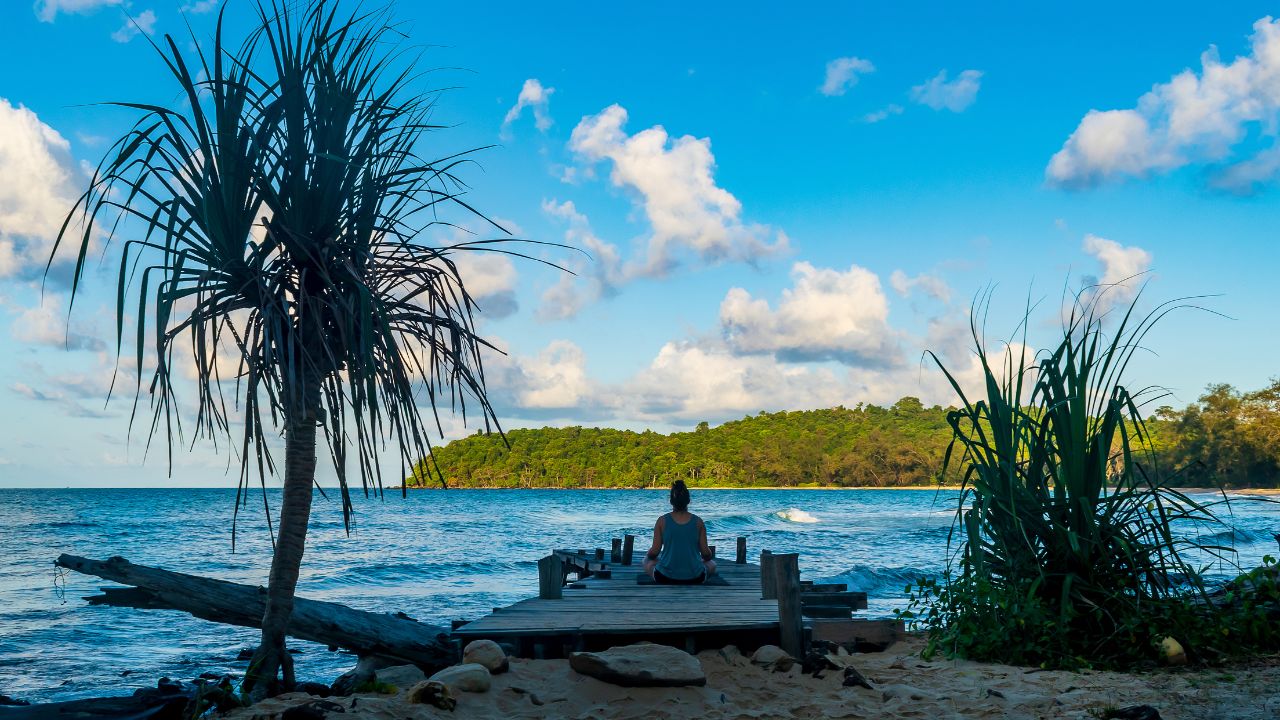 Koh Ta Kiev, Cambodia- Feb, 2020 : a woman doing morning yoga on the wooden pier, Koh Ta Kiev, Cambodia