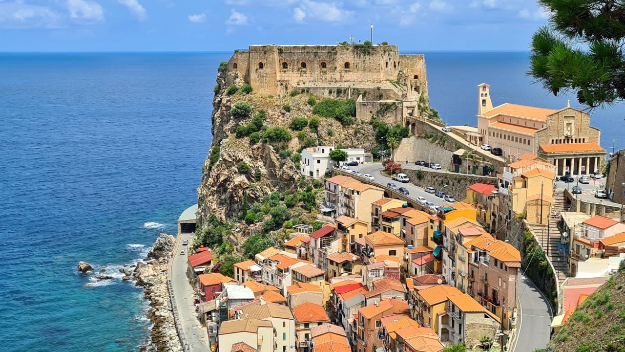 Scilla, Calabria, Italy - July 05 2023: The majestic fortress "Castello Ruffo di Scilla", which rises on a rocky cliff above the Tyrrhenian Sea.Scilla, Calabria, Italy - July 05 2023: The majestic fortress "Castello Ruffo di Scilla", which rises on a rocky cliff above the Tyrrhenian Sea.