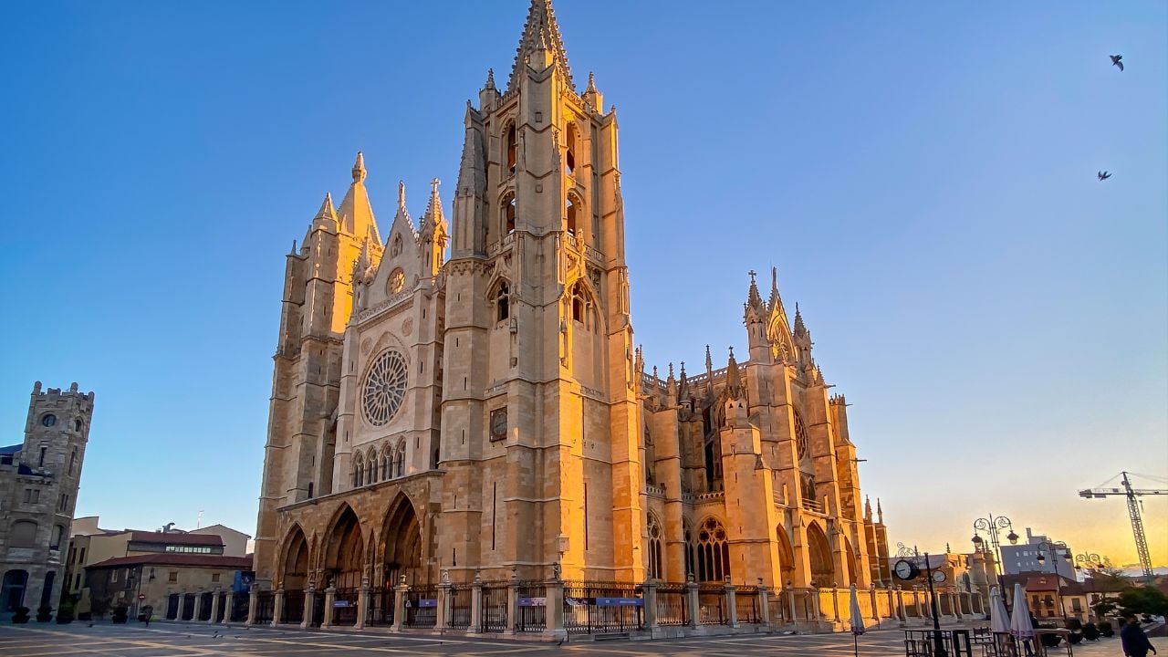 General view of the Gothic Cathedral of León in Castilla y León, Spain, from the square with unrecognizable people walking by