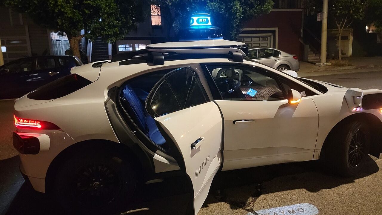 Waymo robotaxi with an open door.