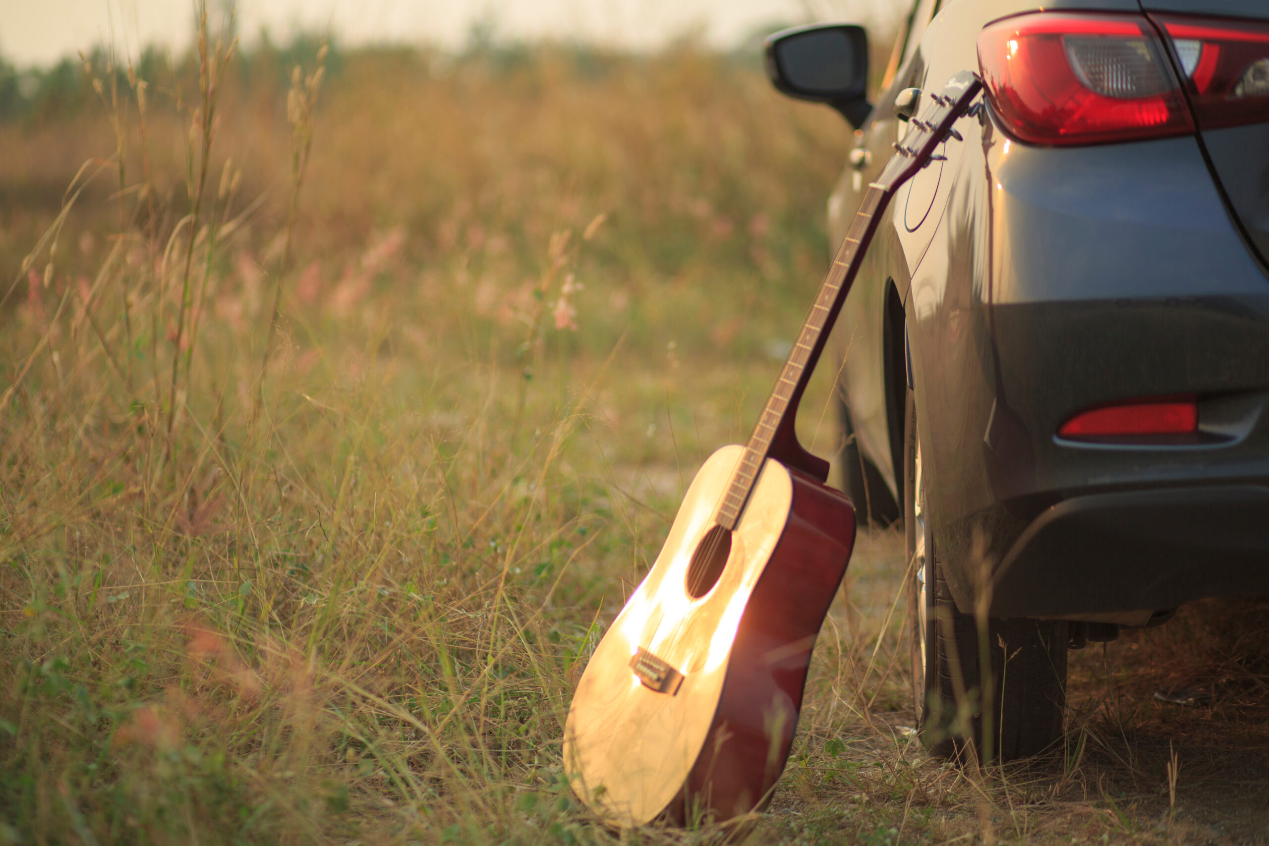 guitar next to car