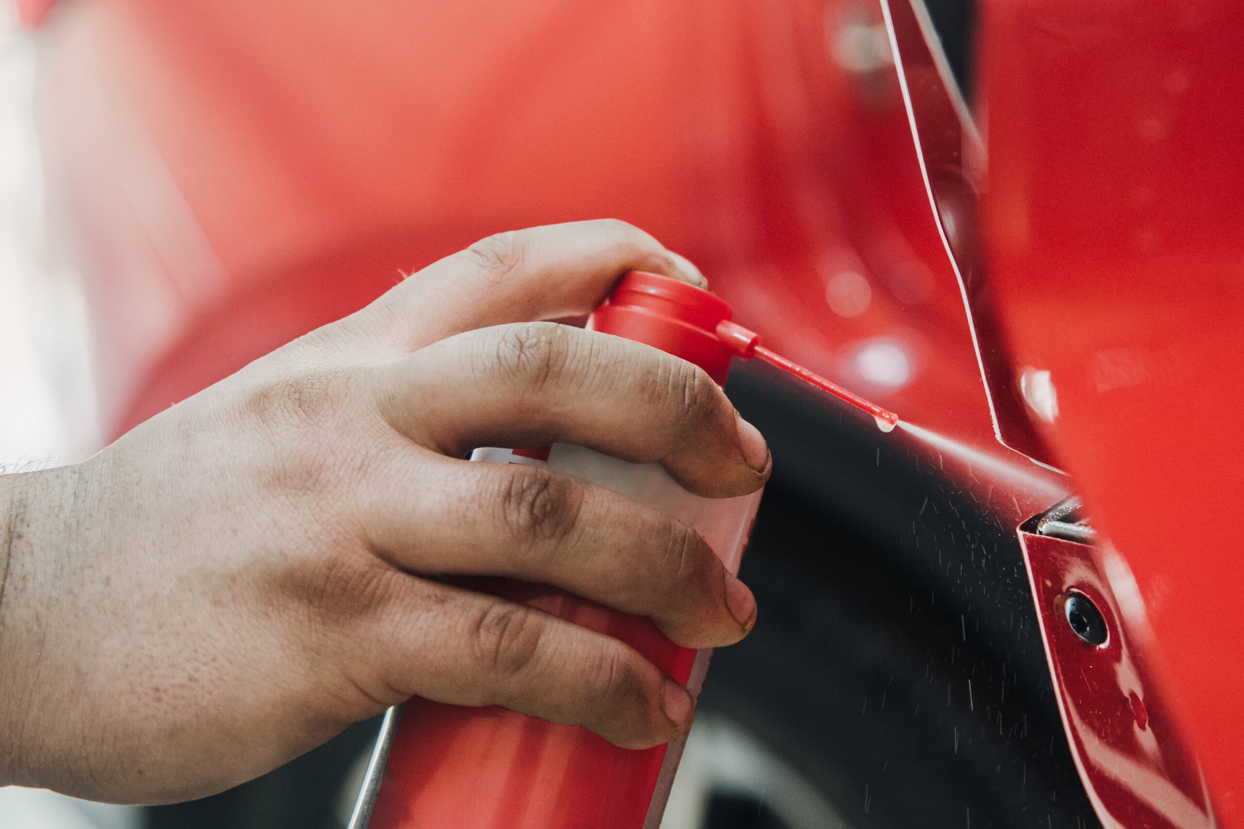 spraying car with arosol can