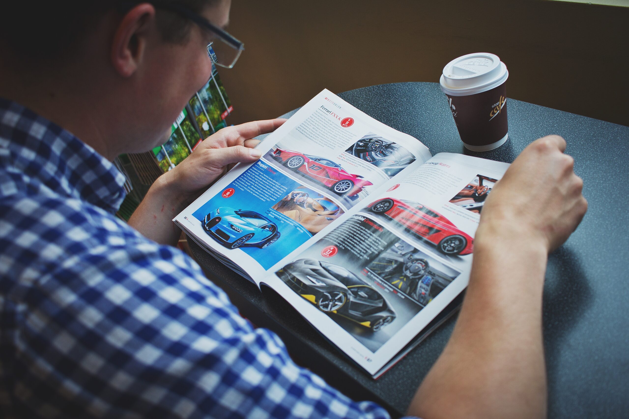man reading car magazine