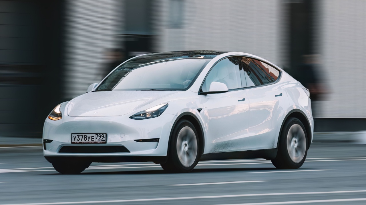 Moscow, Russia - 27 September 2023: Tesla Model Y all electric car driving down the street