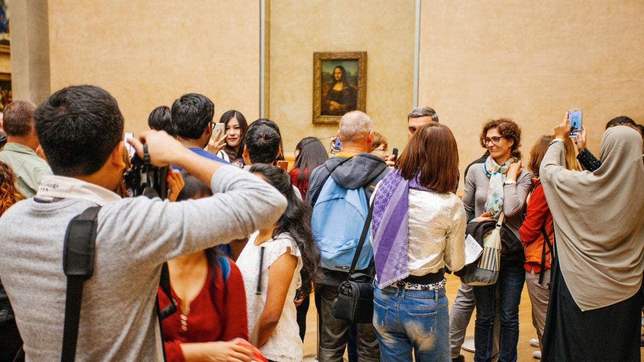 PARIS, FRANCE - October 11, 2016: Visitors take photo of Leonardo DaVinci's "Mona Lisa" at the Louvre Museum