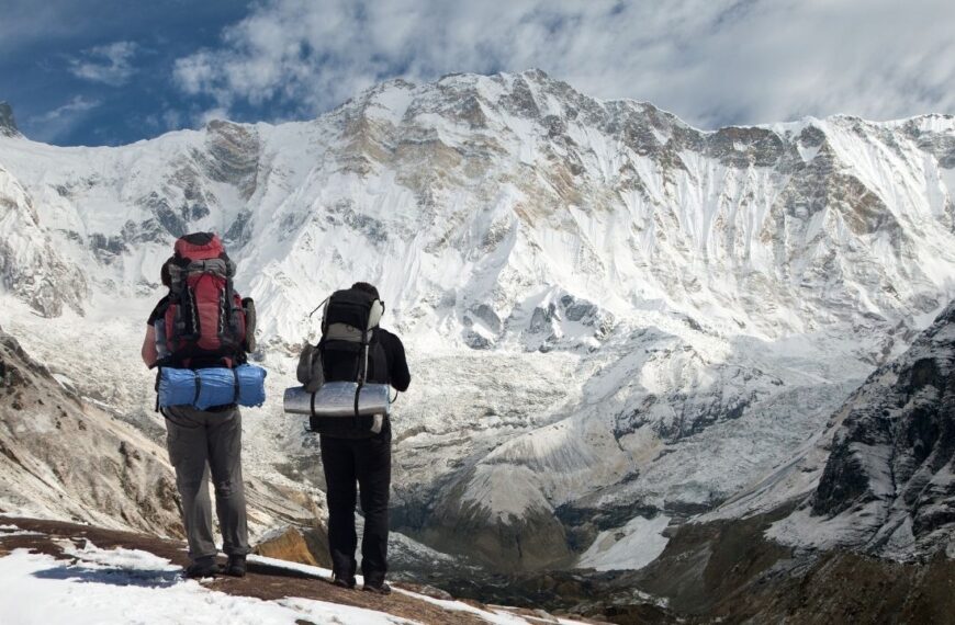 View of Mount Annapurna with two climbers, round Annapurna circuit trekking trail, Nepal