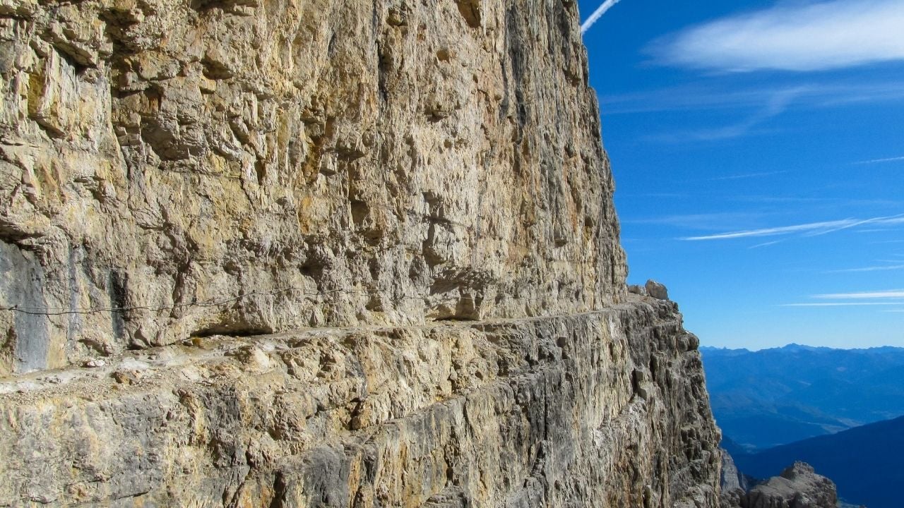 Via delle Bocchette Alte Via ferrata route in the Dolomiti di Brenta Alps in Italy. Equipped with bridge and steel cable and ladder hiking and climbing path in the high rocky mountains in Dolomites
